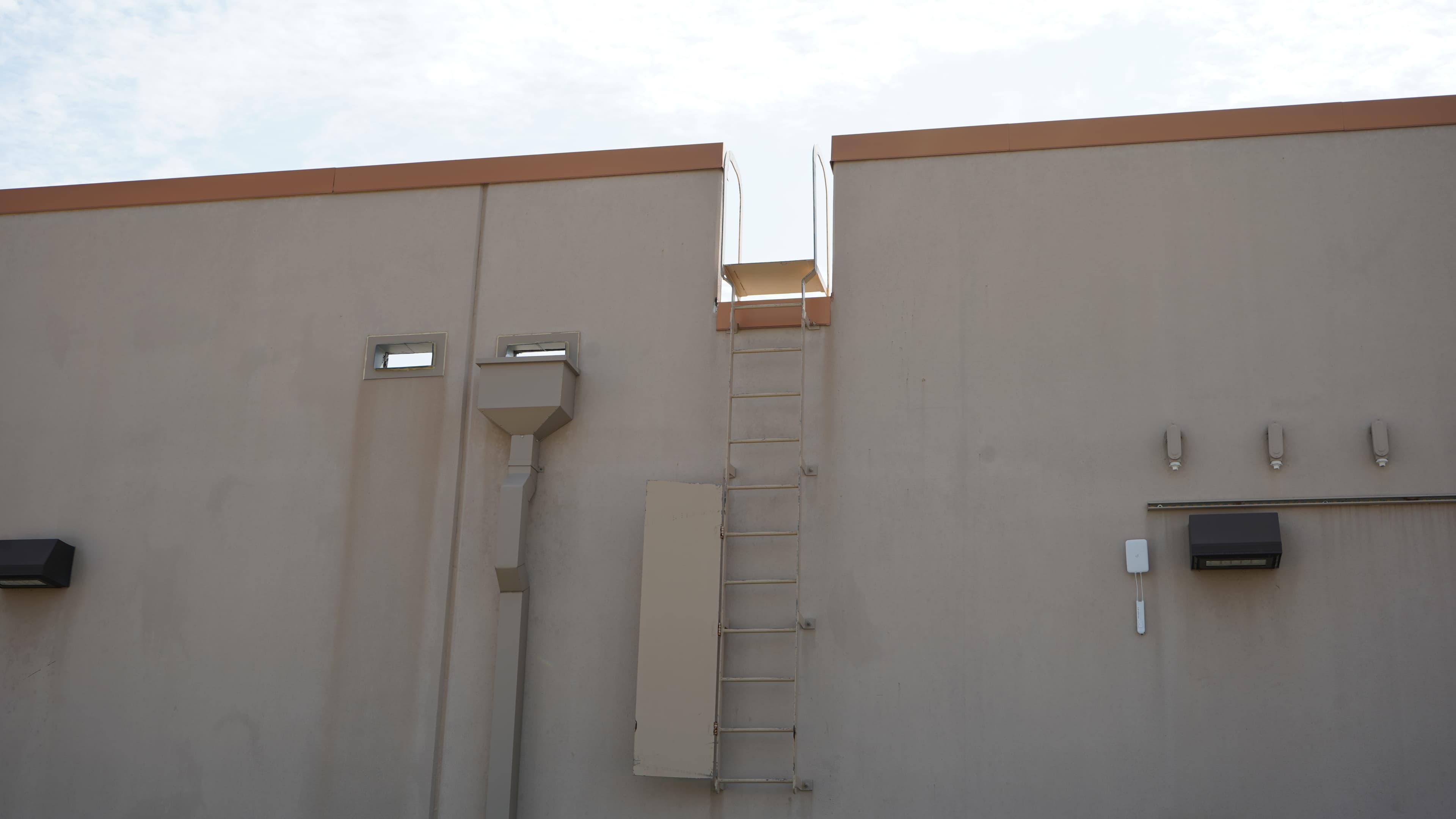 Commercial building exterior showing lighting, gutters, and facade — all covered under MSM's facilities maintenance contract