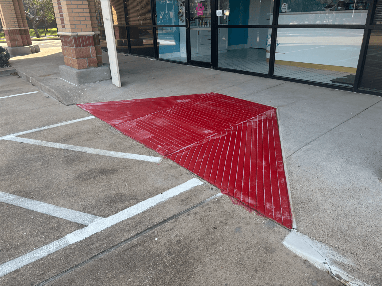 ADA compliant ramp with painted surface and wheel stops