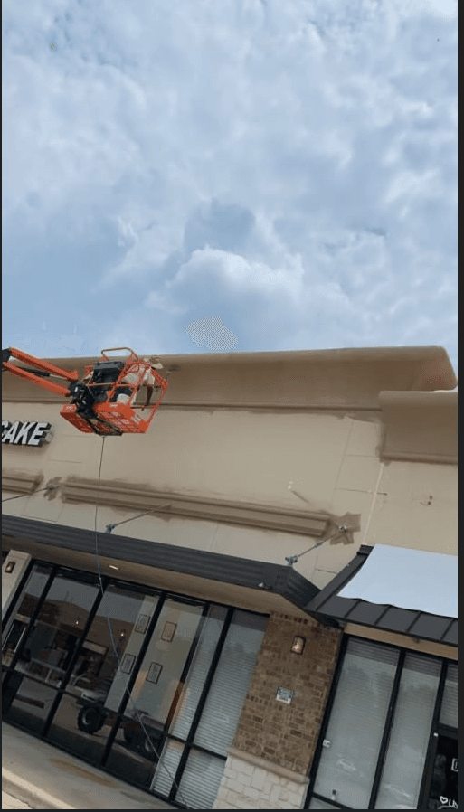 MSM crew applying exterior coating to a commercial retail building
