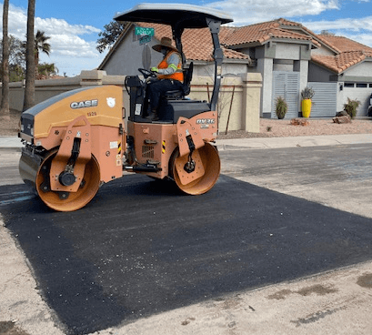 Asphalt paving and parking lot repair crew at work