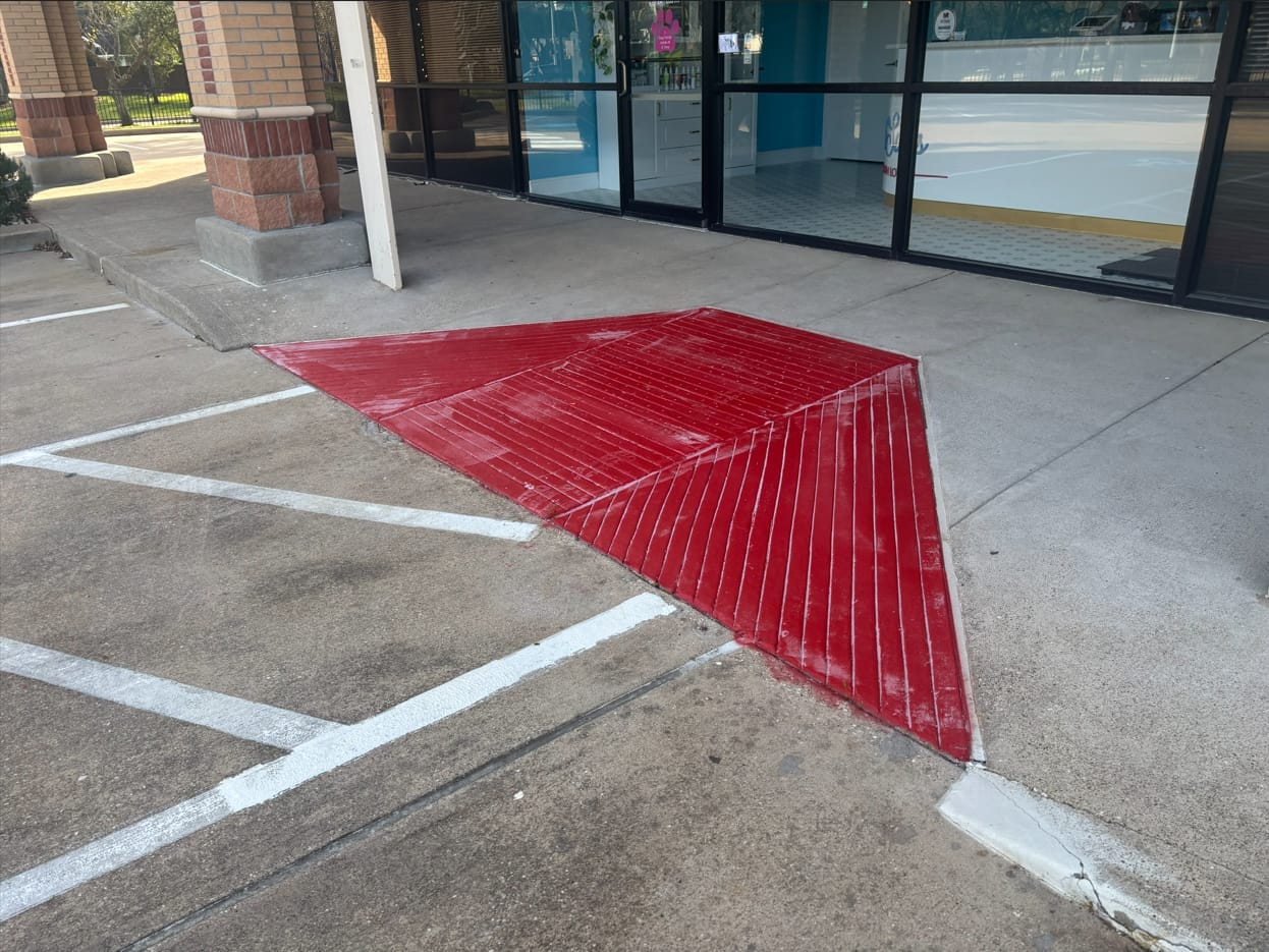 ADA compliant ramp with painted surface and wheel stops