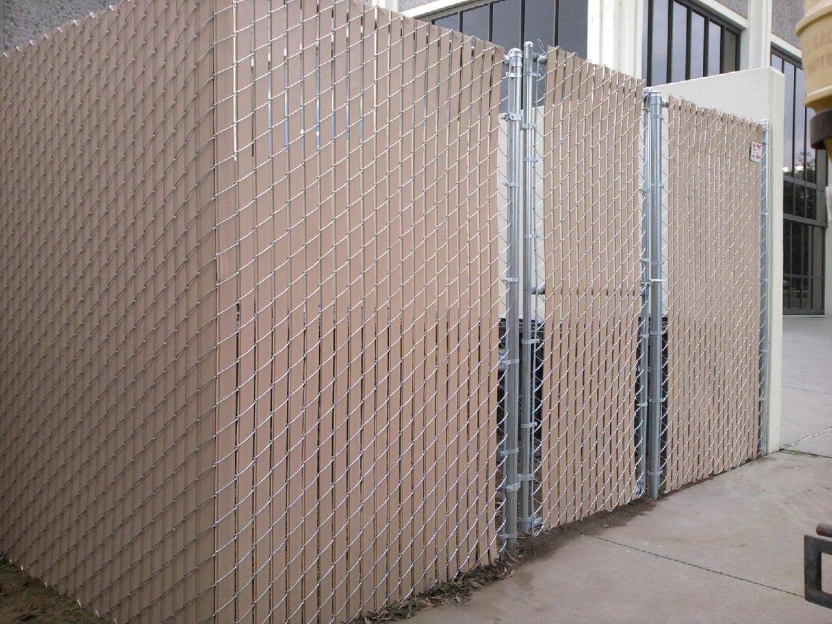 Chain link fence with privacy slats installed at commercial building