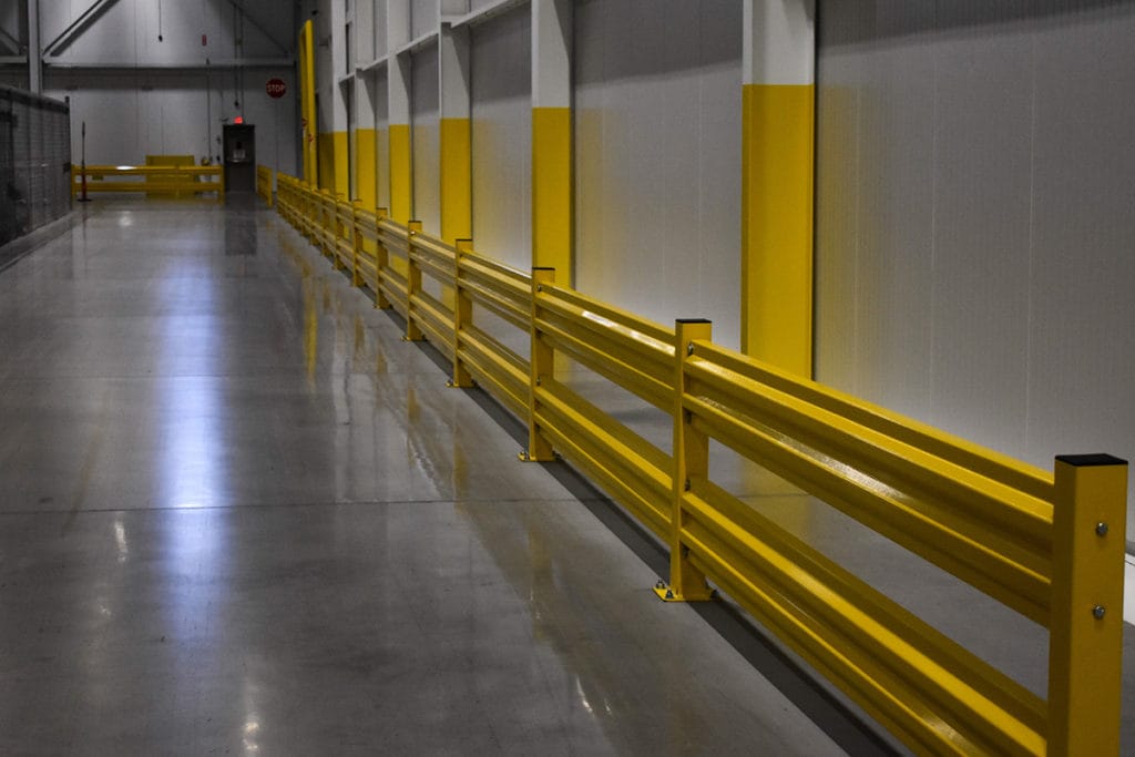 Yellow safety guard rails installed inside a warehouse facility