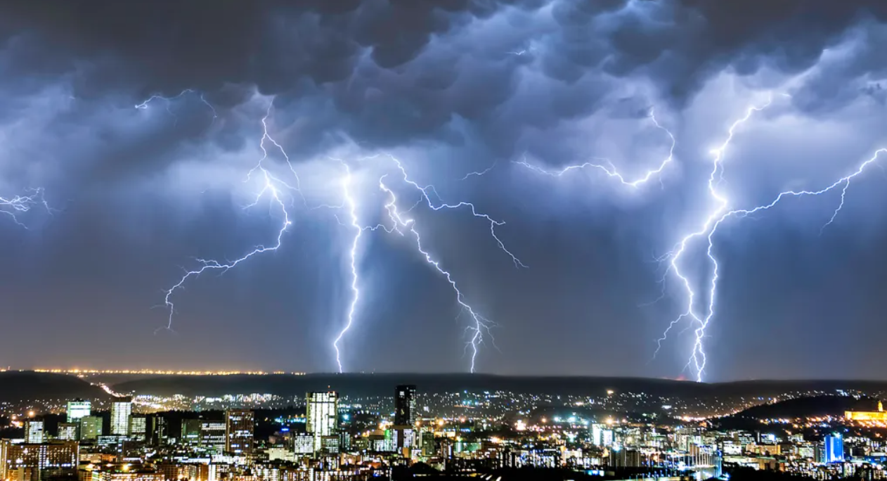 Lightning storm over a city skyline at night — hurricane season in Greater Houston
