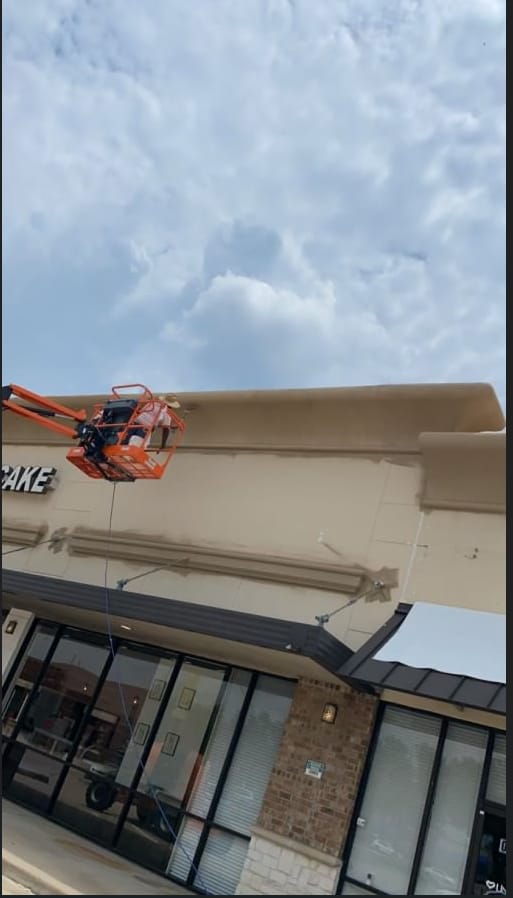 MSM crew applying exterior coating to a commercial retail building